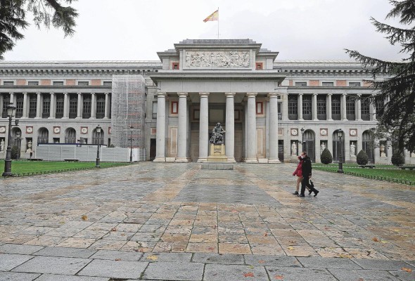 Dos personas pasan ante el Museo del Prado, en Madrid, España. Dos personas pasan ante el Museo del Prado, en Madrid, España.