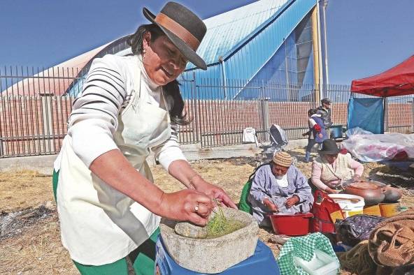 Una mujer indígena aimara prepara una llajua en un batán de piedra, durante el festival de la salsa picante, en El Alto (Bolivia). Una mujer indígena aimara prepara una llajua en un batán de piedra, durante el festival de la salsa picante, en El Alto (Bolivia).