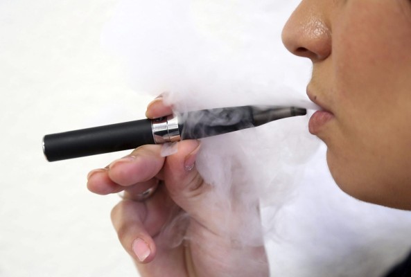 epa03610675 A person smokes an electronic cigarette in Nice, France, 05 March 2013. Media reports on 05 March state that French Minister for Social Affairs and Health Marisol Touraine is to launch an investigation into the side effects of the flavours used in the electronic cigarettes. The French Agency for Safety and Health Products (AFSSAPS) already in 2011 had recommended not to use them. EPA/SEBASTIEN NOGIER epa03610675 A person smokes an electronic cigarette in Nice, France, 05 March 2013. Media reports on 05 March state that French Minister for Social Affairs and Health Marisol Touraine is to launch an investigation into the side effects of the flavours used in the electronic cigarettes. The French Agency for Safety and Health Products (AFSSAPS) already in 2011 had recommended not to use them. EPA/SEBASTIEN NOGIER