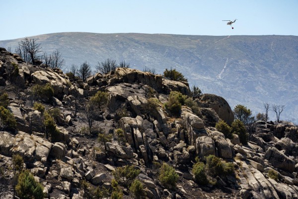 Un helicóptero recorre la zona afectada por el incendio Un helicóptero recorre la zona afectada por el incendio