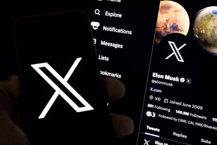 Una imagen ilustrativa muestra a un usuario sosteniendo un teléfono móvil con el logo 'X' frente a la página de Elon Musk. Una imagen ilustrativa muestra a un usuario sosteniendo un teléfono móvil con el logo 'X' frente a la página de Elon Musk.