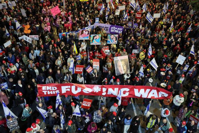 La gente sostiene carteles y ondea banderas durante una protesta antigubernamental que pide acciones para asegurar la liberación de los rehenes israelíes que se encuentran cautivos desde los ataques del 7 de octubre de 2023. La gente sostiene carteles y ondea banderas durante una protesta antigubernamental que pide acciones para asegurar la liberación de los rehenes israelíes que se encuentran cautivos desde los ataques del 7 de octubre de 2023.