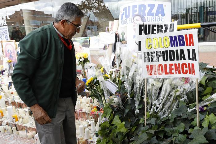 Un hombre observa un altar por la salud del senador Miguel Uribe. Un hombre observa un altar por la salud del senador Miguel Uribe.