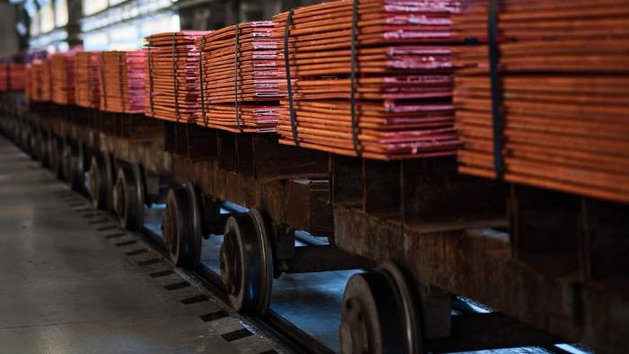Pilas de hojas de cobre atadas con cintas en vagones de ferrocarril en almacén en una planta de refinería metálica. Pilas de hojas de cobre atadas con cintas en vagones de ferrocarril en almacén en una planta de refinería metálica.