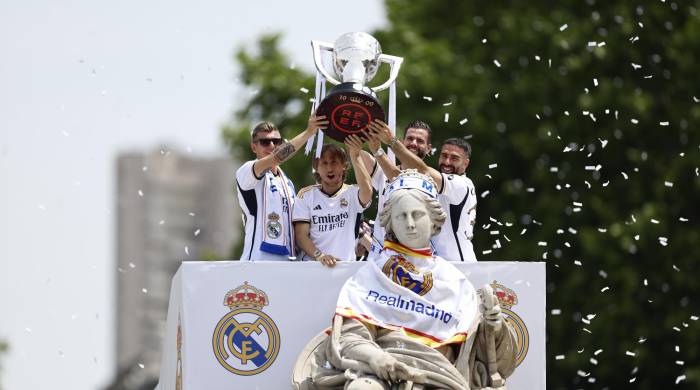 El capitán del Real Madrid, Nacho Fernández, junto a los jugadores, Toni Kroos (i), Luka Modric (2i) y Daniel Carvajal levantan la copa junto a la diosa Cibeles.