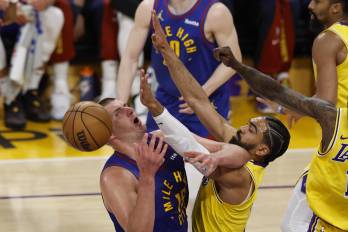 El serbio Nikola Jokic (i) y Gabe Vincent (c-d) durante el partido entre Denver Nuggets y LA Lakers.