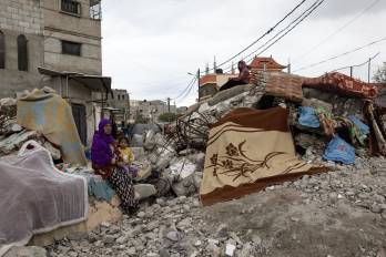 Una mujer palestina y un niño junto a una casa destruida en Rafah, en el sur de la Franja de Gaza, el 28 de enero de 2024.