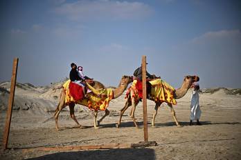 La gente monta en camello por las dunas del desierto de Al Wakrah, al sur de Doha, en una imagen de archivo.