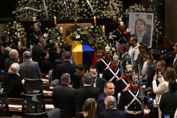 Miembros de la Guardia Presidencial realizan el cambio de guardia frente al ataúd y el retrato del candidato presidencial colombiano asesinado Miguel Uribe mientras su cuerpo yace en vela en el Congreso en Bogotá el 12 de agosto de 2025.
