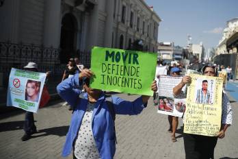 Personas sostienen carteles durante una marcha este domingo, en San Salvador (El Salvador). EFE/ Rodrigo Sura