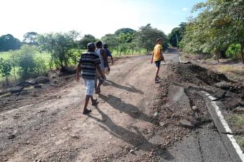 Lugareños cruzan el tramo de una calle productora colapsada en la comunidad costera y zona productora de Búcaro, en el distrito de Tonosí. Las vías inaccesibles dejan al agro santeño en punto ciego, provocando pérdidas y riesgos sanitarios en el ganado.