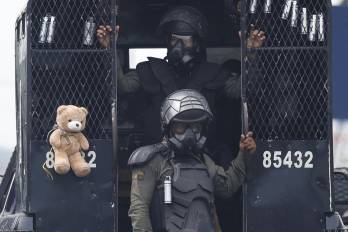 Integrantes de la Unidad de Control de Multitudes (UCM) bajan de un vehículo durante una manifestación esté sábado, en Changuinola, Bocas del Toro (Panamá). La provincia de Bocas del Toro amaneció con las telecomunicaciones cortadas y bajo el estado de urgencia decretado por el Gobierno.