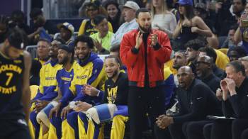El base de los Golden State Warriors Stephen Curry anima a su equipo durante uno de los partidos de las semifinales de la Conferencia Oeste contra Minnesota Timberwolves.