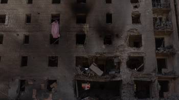 Una mujer limpia los escombros de un apartamento en un edificio residencial muy dañado tras un ataque aéreo ruso, en Selydove, la región oriental de Donetsk, el 27 de junio de 2024,