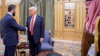 Una imagen proporcionada por el Palacio Real Saudí muestra al príncipe heredero saudí Mohammed bin Salman (der.) observando cómo el presidente estadounidense Donald Trump (centro) estrecha la mano del presidente interino sirio Ahmed al-Sharaa en Riad el 14 de mayo de 2025.