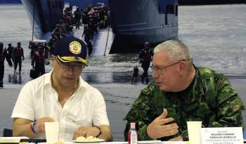 Petro (i) y el comandante de las Fuerzas Militares Helder Fernán Giraldo (d) participan en la entrega de un territorio libre de sospecha de minas antipersonales.