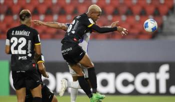 Anthony Stewart (d) de CAI salta por un balón en un partido de la fase de grupos de la Copa Centroamericana de la Concacaf.