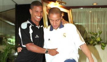 Fotografía de archivo sin fecha del jugador brasileño Marcelinho Carioca (i), exjugador del Valencia, con su compatriota Roberto Carlos del Real Madrid bromeando en la entrada de un hotel de Sao Paulo (Brasil). EFE/ Archivo