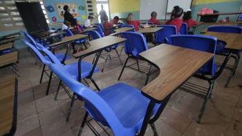 Grupo pequeño de estudiantes dentro de un aula en clases en ciudad de Panamá.