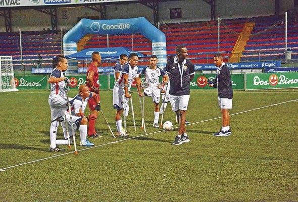 El técnico Clifford Brown (segundo de derecha a izquierda) se retira del campo, tras conversar con el equipo.