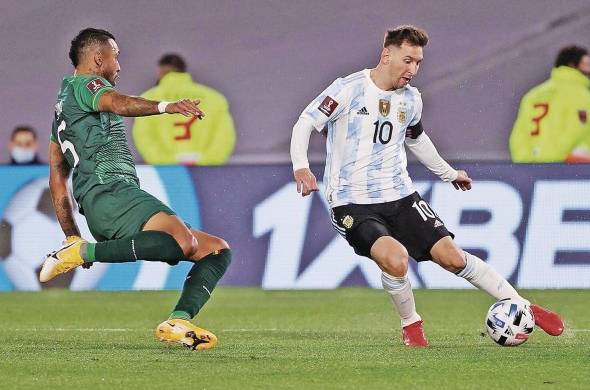 Lionel Messi disputa el balón con Adrián Jusino.