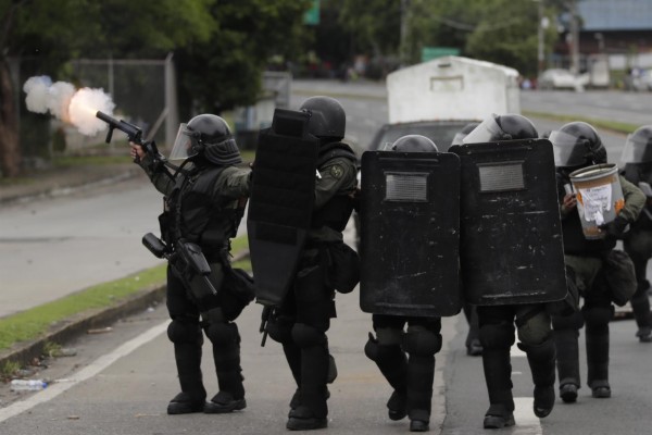Agentes de la policía nacional lanzan bombas lacrimógenas hoy, durante una protesta contra la subida del precio del combustible,
