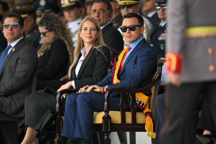 Ecuador's President Daniel Noboa (R) and his wife, First Lady Lavinia Valbonesi, attend the change of command ceremony for the Joint Command of the Armed Forces at the Eloy Alfaro Superior Military School on the outskirts of Quito on November 26, 2025. (Photo by Rodrigo BUENDIA / AFP)