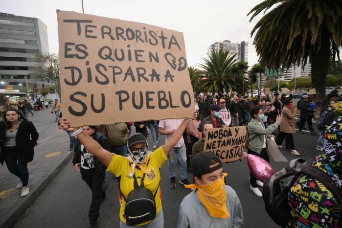 Un manifestante exhibe una pancarta que dice “Terrorista es quien dispara contra su propio pueblo”, durante una protesta antigubernamental en apoyo al paro nacional convocado por la CONAIE (la mayor organización indígena de Ecuador) en Quito el 2 de octubre.