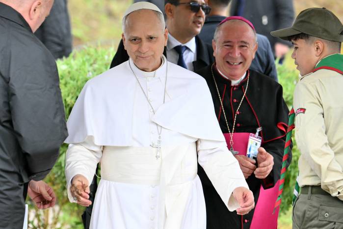 Pope Leon XIV cleans his hands after planting a tree during a visit at the archaeological site of Hippo, in Annaba on April 14, 2026. (Photo by Alberto PIZZOLI / AFP)