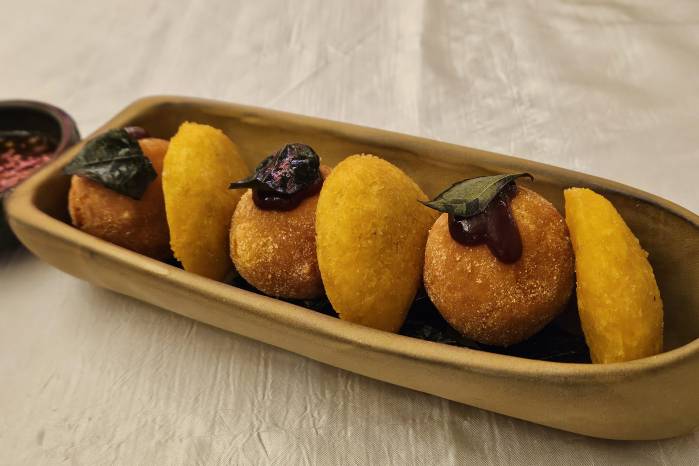 Empanaditas de cáscara de plátano y croquetas de pixbae con mermelada de tomate de árbol.