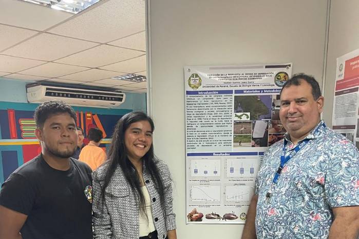 Estudiantes Lázaro Guerra, Madelein Aparicio y el Dr. Roberto Lombardo con el cartel del proyecto en el Congreso Científico Nacional de la UP en Veraguas, 2025.