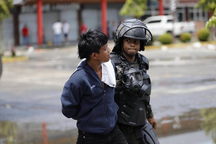 Un integrante de las Fuerzas Armadas custodia a un manifestante durante una protesta este viernes en la ciudad de Changuinola una de las principales de la provincia de Bocas del Toro (Panamá).