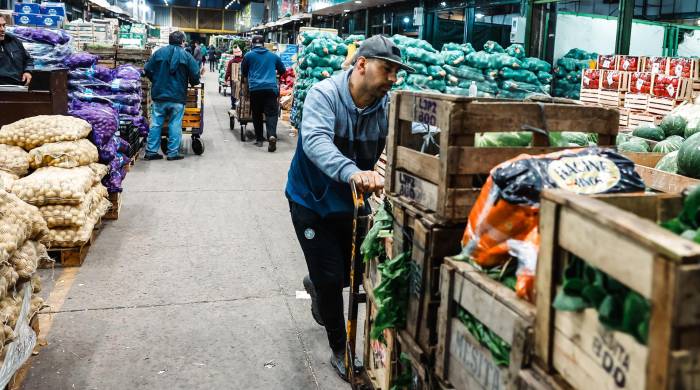 Personas realizan descarga de frutas y verduras, en el mercado central de frutas y verduras, en Buenos Aires (Argentina), en una fotografía de archivo.