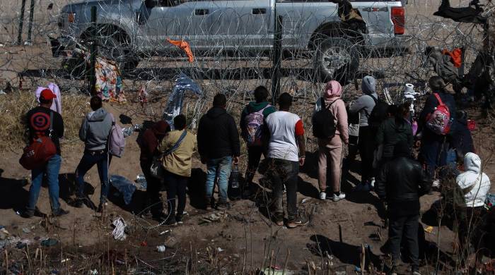Fotografía del 2 de febrero de 2024, donde se observa a migrantes cruzando vallas de alambre que dividen a México con Estados Unidos, en Ciudad Juárez, Chihuahua.