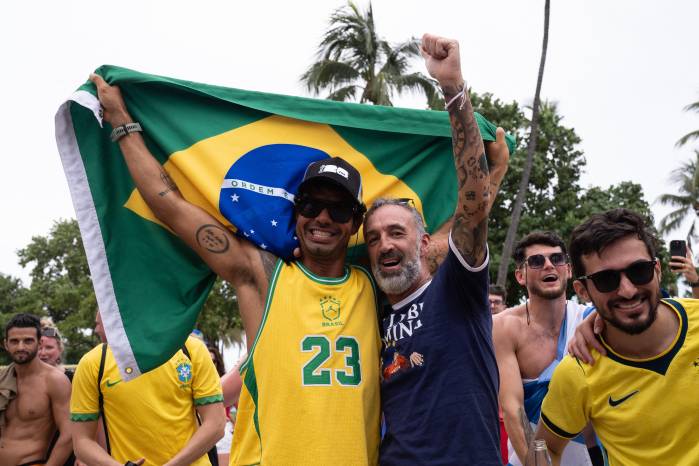 Aficionados de Brasil y Escocia se reúnen en Ocean Drive, en Miami Beach, antes del partido de la Copa Mundial de la FIFA de este miércoles.